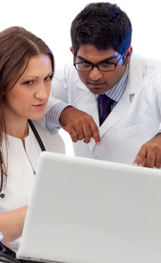 Medical professionals looking at a laptop.